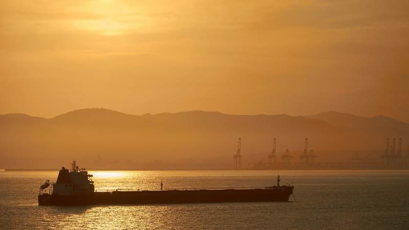 Oil halves losses after OPEC output cut deal report
