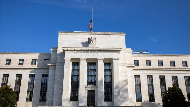 Fed holds interest rates, signals further hikes ahead