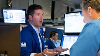 Wall Street pares gains after Omicron found in US