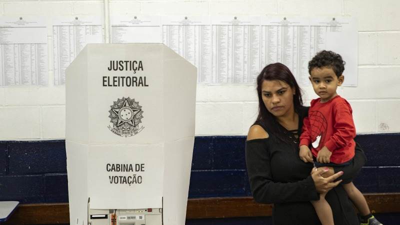 Bolsonaro in narrow lead as half of votes counted in Brazil elections