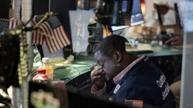 US markets close lower after cut to banks’ credit ratings