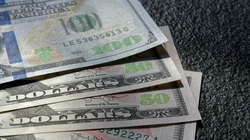 Dollar hits 4-week low against yen, drops under ¥148 mark