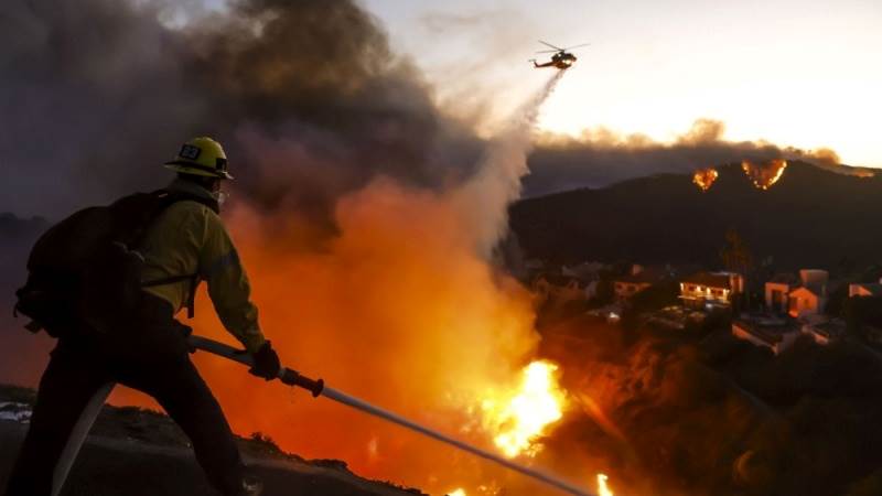 Fire officials brace for winds as LA wildfires spread